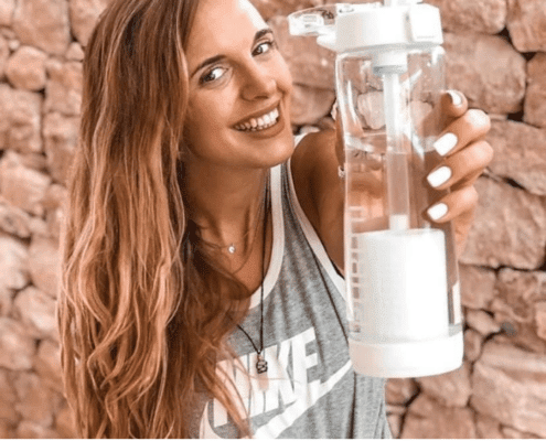 Brands at Beauty of Action, a lady holding a Puritii Tritan Water Bottle